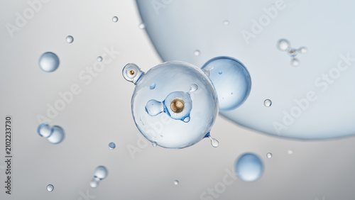 Transparent biological cell with golden nucleus and inner bubble structure floating in liquid