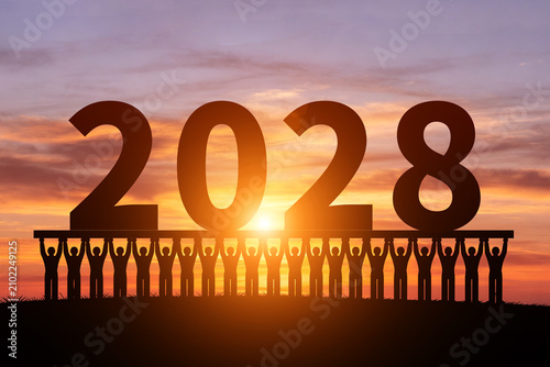 In the morning sun, numerous silhouettes of children are holding up the year2028