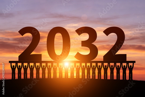 In the morning sun, numerous silhouettes of children are holding up the year 2032