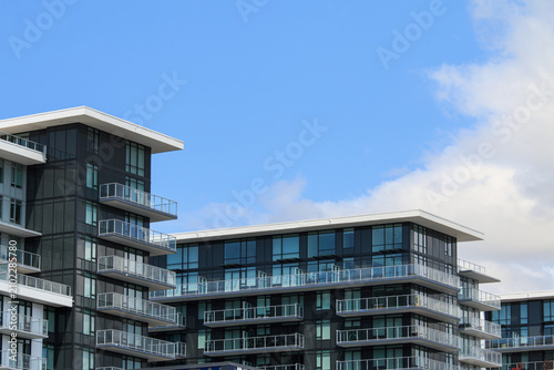 Photography Modern apartment building under blue sky in Vancouver, Canada