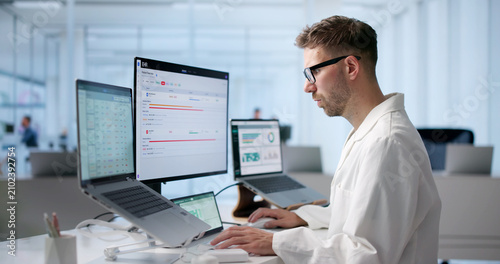 фотографія Young Male Doctor Is Reviewing Patient Medical Records