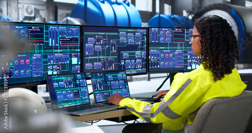 Woman Engineer Checks Turbine Control System Using Laptop