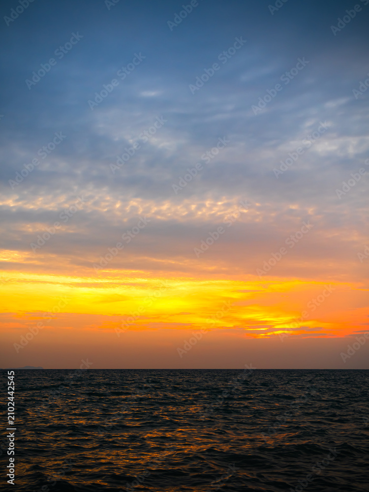 Obraz premium Sea sunset sky evening sunrise cloud weather dramatic landscape goldent and indigo color gradient pastel horizon, twilight yellow golden reflection morning nature environment energy ecosystem change.