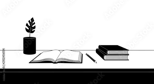 Open book and plant on minimalist desk with clean background