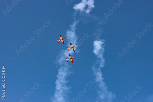 Принти на полотні Three Aerobatic Planes Flying in Formation with White Smoke Trails
