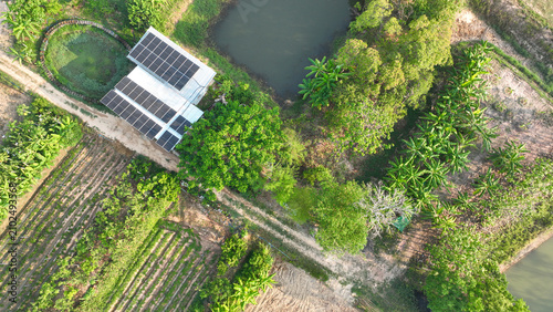 Quadro su tela Rooftop solar panels powering a sustainable rural farm surrounded by ponds, trees, organic agriculture, and renewable energy infrastructure supporting self sufficient living and clean electricity