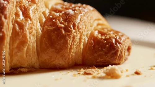 Ultra Macro Shot of A Flaky Croissant Layer Edge on A Pale Cream Background, Highlighting Its Texture and Buttery Finish