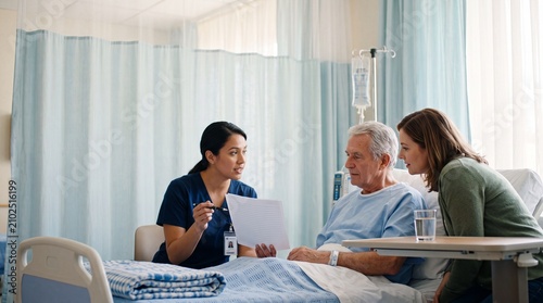 A compassionate nurse reviews a medical chart with a senior male patient and a concerned family member, conveying information and reassurance in a well-lit hospital room.