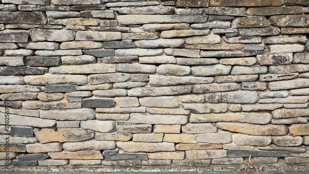 Obraz premium Close Up View of Weathered Natural Dry Stone Wall Texture