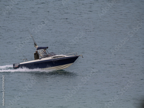 Blue And White Speeding Fishing Boat
