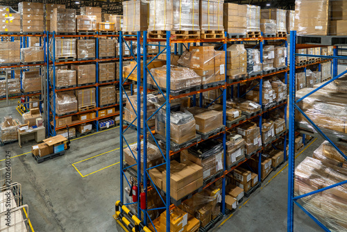 Interior of logistics warehouse with full of pallets and racks