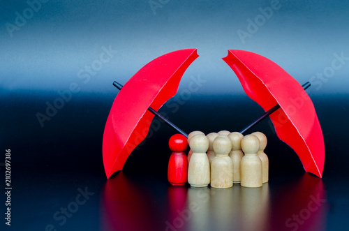 Leadership team gathered under umbrella symbolizing collective protection, insurance safety, and reliable guidance.