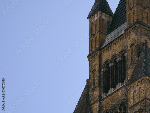 Historic Romanesque Church Tower against a Clear Blue Sky