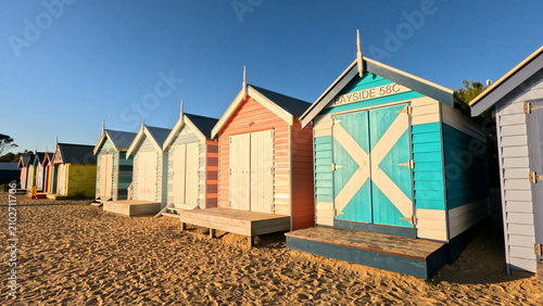 Принти на полотні Colorful Brighton Beach Bathing Boxes Under a Clear Blue Sky
