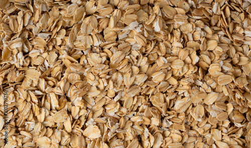 Oat flakes textured pattern, rolled oatmeal macro background