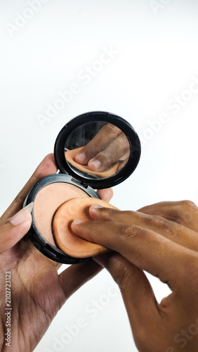 Принти на полотні A woman is applying makeup using a powder puff