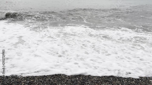 waves roll ashore on a stormy day