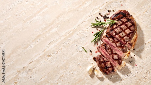 Sliced grilled steak with rosemary peppercorns and garlic on marble surface full hd 4k stock image download