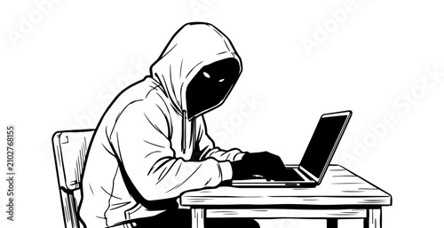 Hooded hacker working on laptop at desk