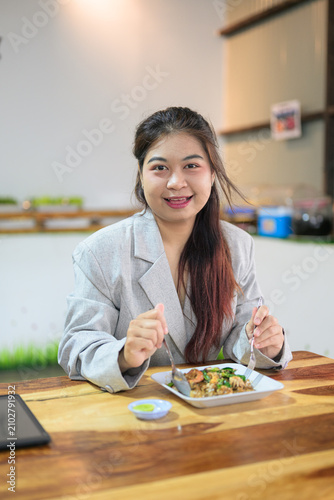 Smiling Thai Isan Businesswoman Having Lunch at a Local Restaurant