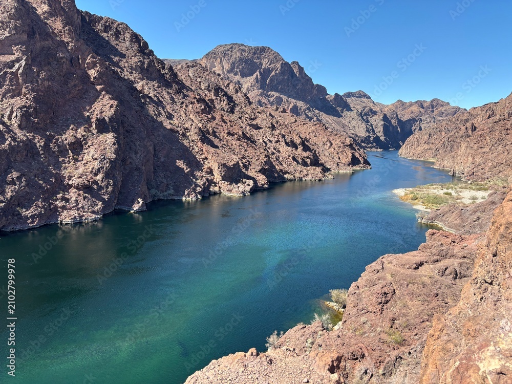 Fototapeta premium Scenic View of a River Surrounded by Rocky Mountains