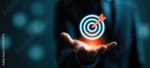 Fototapeta Business Goal Achievement Concept - Arrow Hitting Target in Hand.