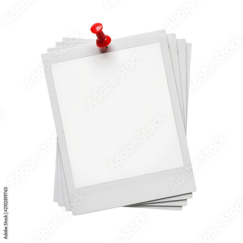 Stack of blank instant photo prints held by a red thumbtack during studio lighting Isolated on transparent background