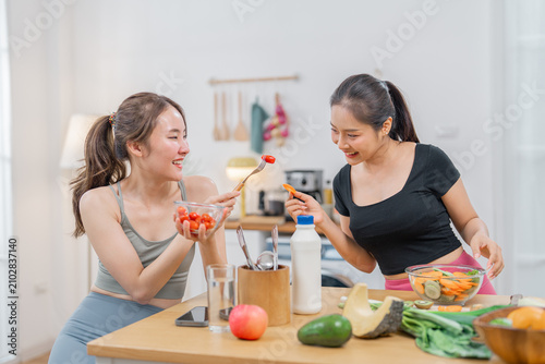 Woman kitchen salad cooking vegetable friend healthy food lifestyle home, two smiling women preparing fresh salad with vegetable on kitchen table during casual healthy meal time