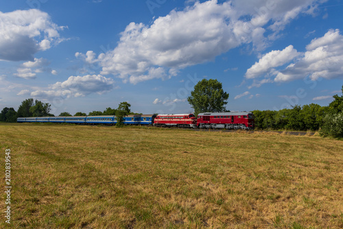 Two diesel locomotives hauling passenger train