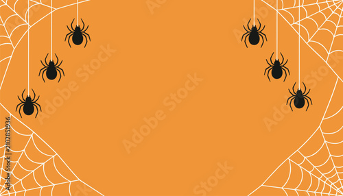 Bild auf Leinwand Five hanging spiders caught in delicate silk webs decorate the edges of a vibrant orange autumn background