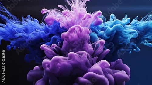 Purple and blue ink swirls underwater against a dark background