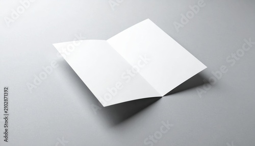A pristine mockup of a folded paper brochure on a solid surface