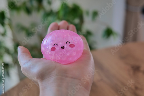 Quadro su tela Hand holding a dumpling shaped stress relief toy