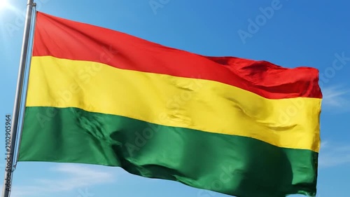 The national flag of Bolivia waving against a clear blue sky
