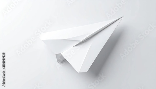 Minimalist white paper airplane on clean white background.