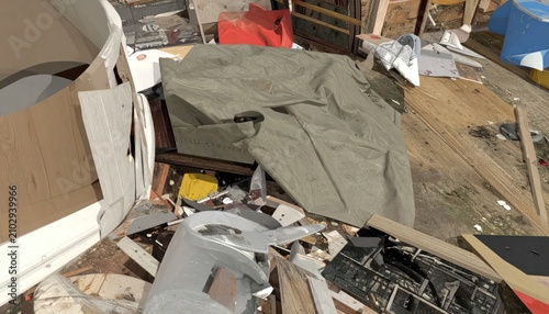 Piled construction debris and renovation waste in messy room.