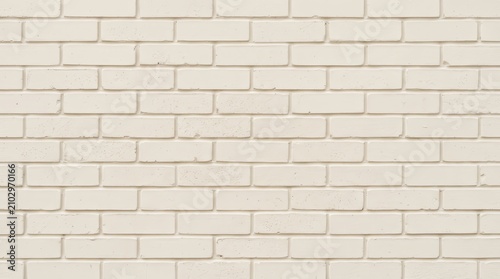 Light cream color painted brick wall with detailed texture close-up.