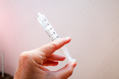 Canvastavla Hand Holding Plastic Syringe – Medical Equipment Close‑Up