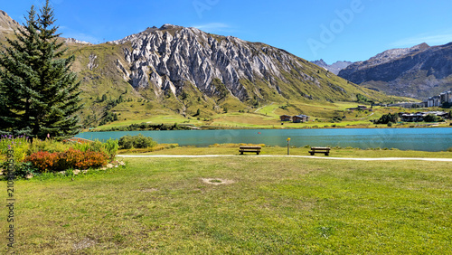 Bild auf Leinwand Wooden benches by Lake Lac de Tignes surrounded by mountains, Savoie, Auvergne-Rhone-Alpes, France, Europe