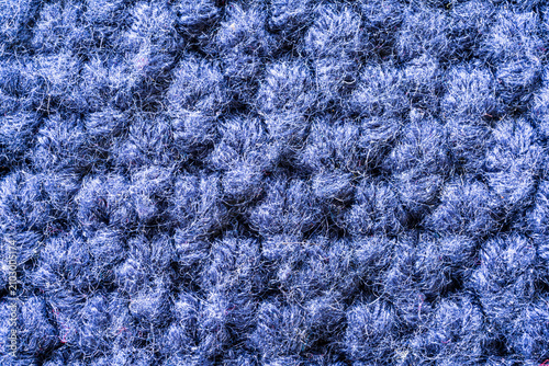 A dense, textured surface of blue yarn or fabric