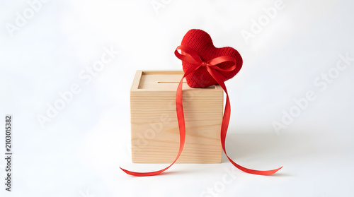 Wooden gift box with red knitted bow ribbon on top