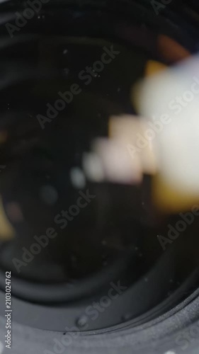 Exploring Optical Mechanics: A Close-Up of an Aperture and Lens Cleaning Technique Unveiling the Intricate Details of Photography Equipment