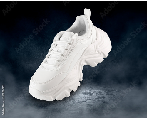 White Sneaker Floating on Dark Smoky Background