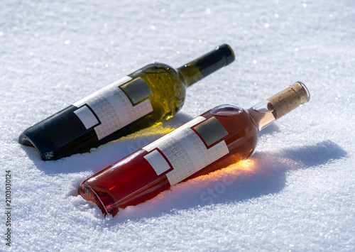 Two Wine Bottles Lying on Snow