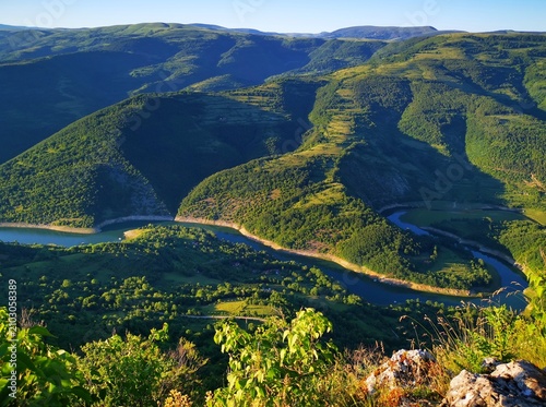 Stunning panoramic view from the Kozji Kamen (Goat Rock) viewpoint overlooking the winding Lake Zavoj (Zavojsko jezero), surrounded by the scenic slopes of Stara Planina.  Beautiful landscape view