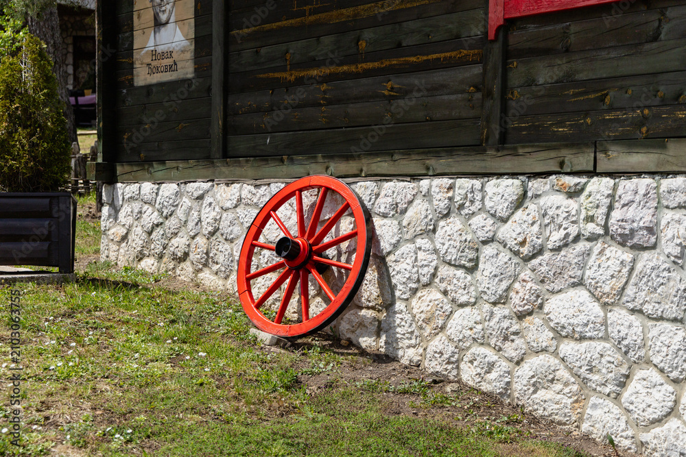 Obraz premium Serbia El Paso City 25.05.2026 Novak Okovi Rustic Wall Beside Red Wagon Wheel
