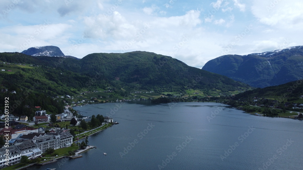 Fototapeta premium Aerial view of Norwegian fjord surrounded by mountains near Bergen