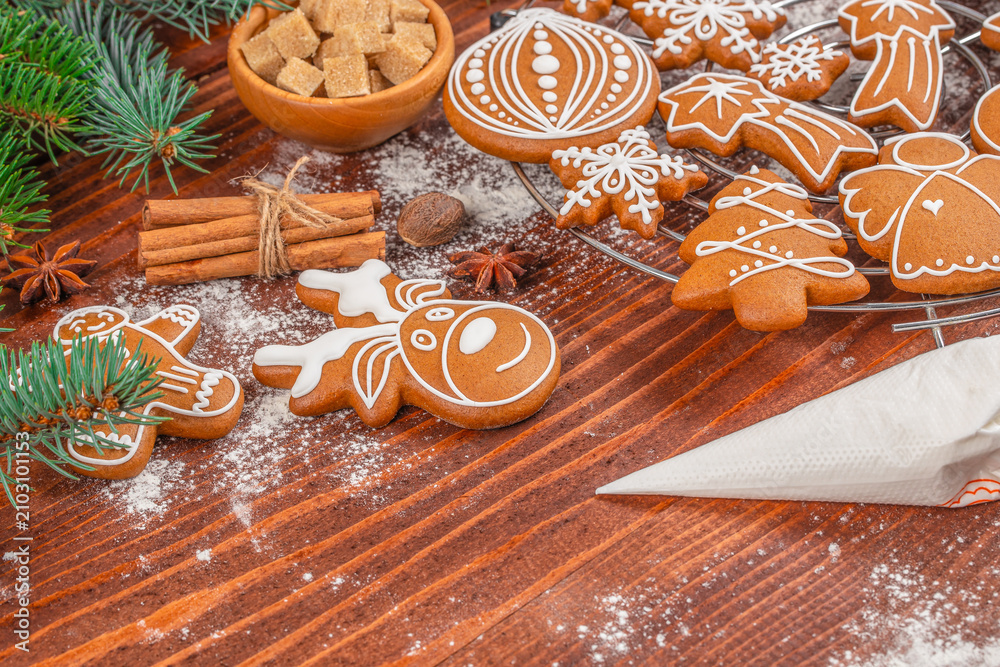 Obraz premium Christmas Gingerbread Cookies with Royal Icing on Rustic Wooden Background