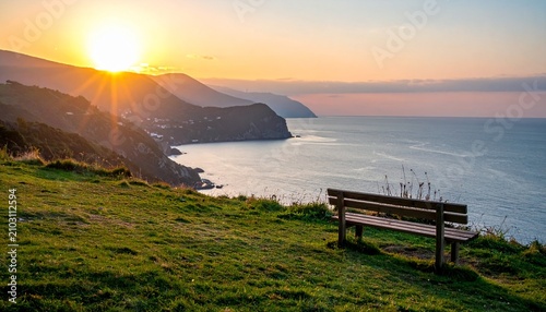 Weathered Wooden Bench Overlooking Calm Sea at Golden Sunset