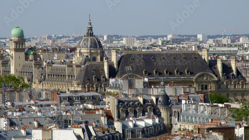 Paris skyline with the dome of Les Invalides and surrounding historic rooftops seen from above.